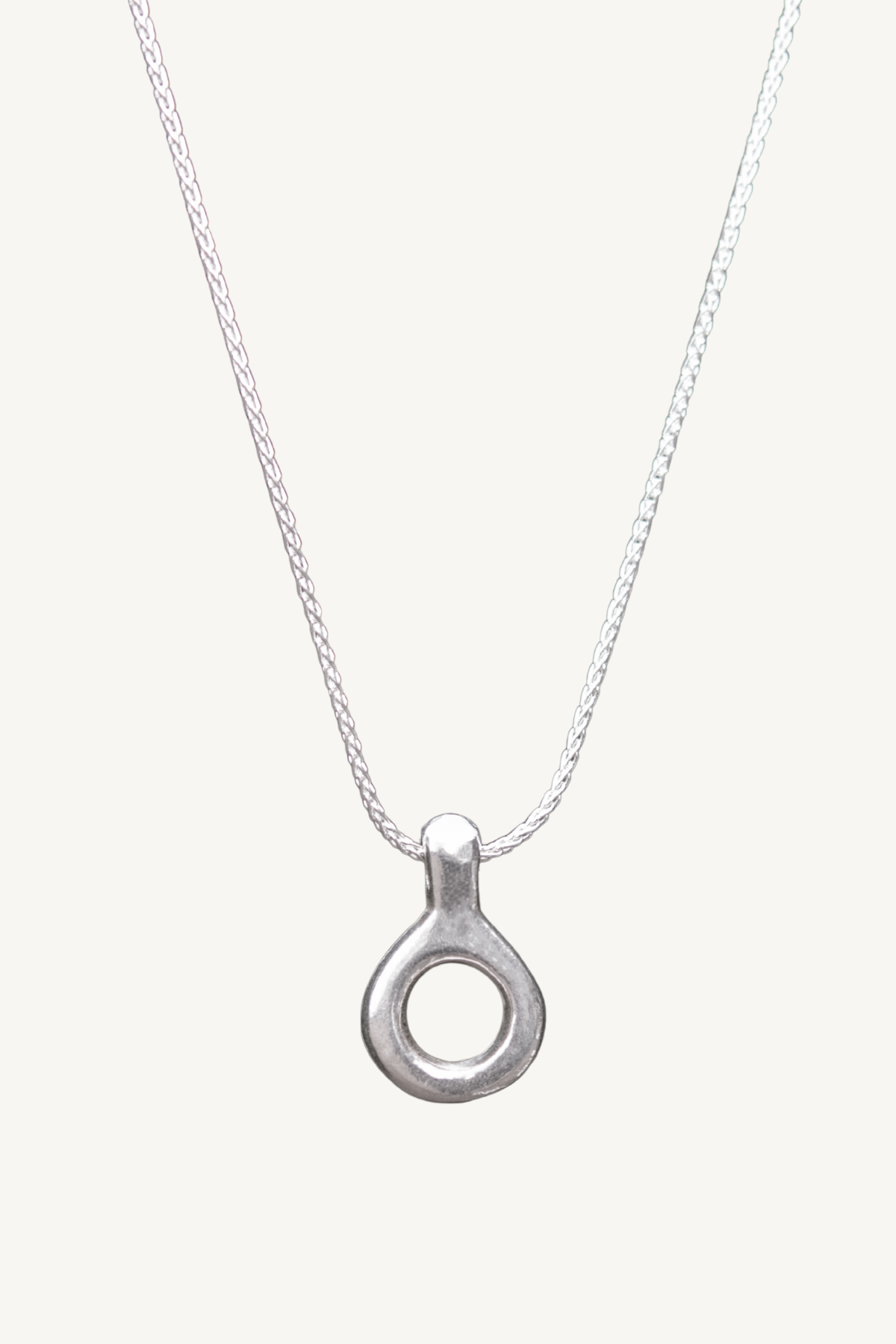 Liz Hanson Metalsmith original design. Hand carved sterling silver necklace charm pendant suspended on a wheat chain.
