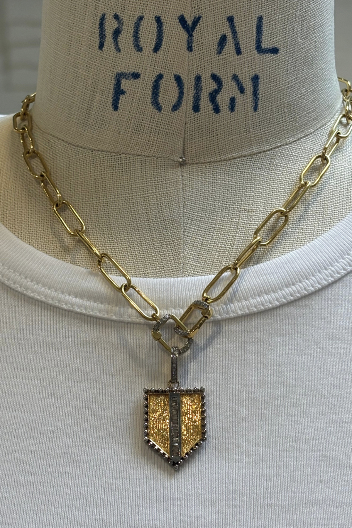 etched shield pendant