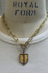 etched shield pendant
